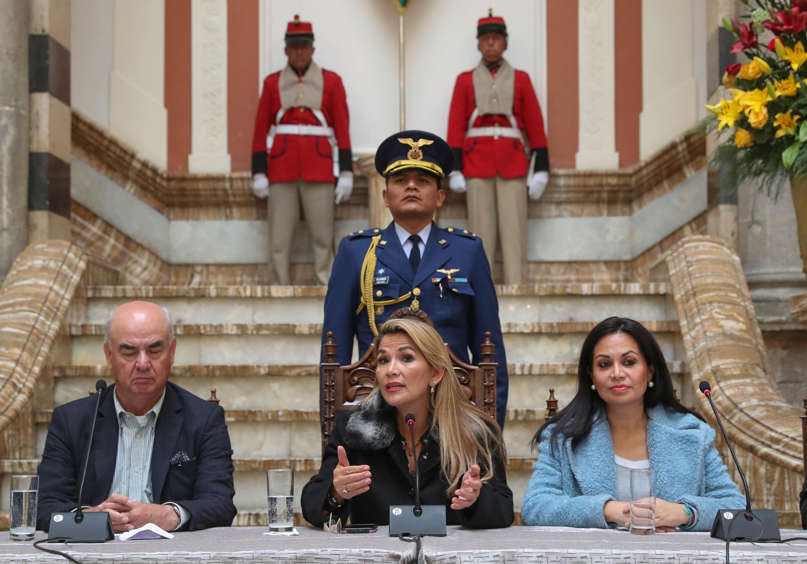 epa07999521 Interim President of Bolivia, Jeanine Anez (C) speaks along with Ministers of Economy, Jose Luis Parada (L) and Minister of Communication, Roxana Lizarraga (R) at a press conference at Government Palace in La Paz, Bolivia, 15 November 2019. Anez announced that this day she hopes to start the process for new elections after the failed elections that led to the resignation of Evo Morales.  EPA/RODRIGO SURA