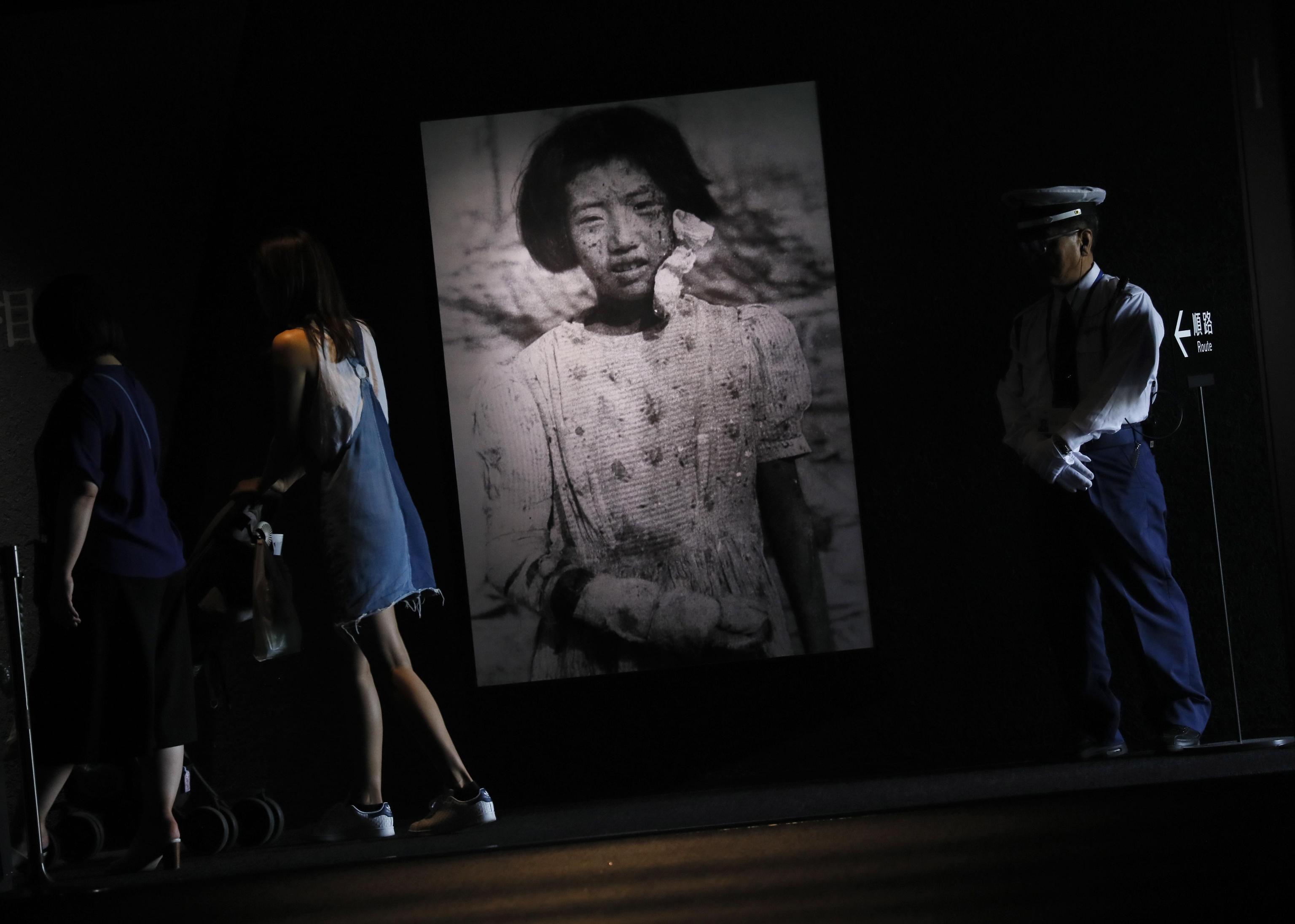 epa07839166 (FILE) - Visitors walking through a photo of 10-year-old atomic bomb survivor girl Yukio Fujii, whose photo was taken on 09 August 1945, just three days after the atomic bombing, at Hiroshima Peace Memorial Museum  in Hiroshima, western Japan, 17 July 2019. The Vatican announced on 13 September 2019 Pope Francis will visit Japan from 23 to 26 November and the WWII atomic bombed cities of Hiroshima Nagasaki. The Pope's visit to Japan will be for the first time since John Paul II visited in 1981. Fuji died at the age of 42 in 1977.  EPA/KIMIMASA MAYAMA