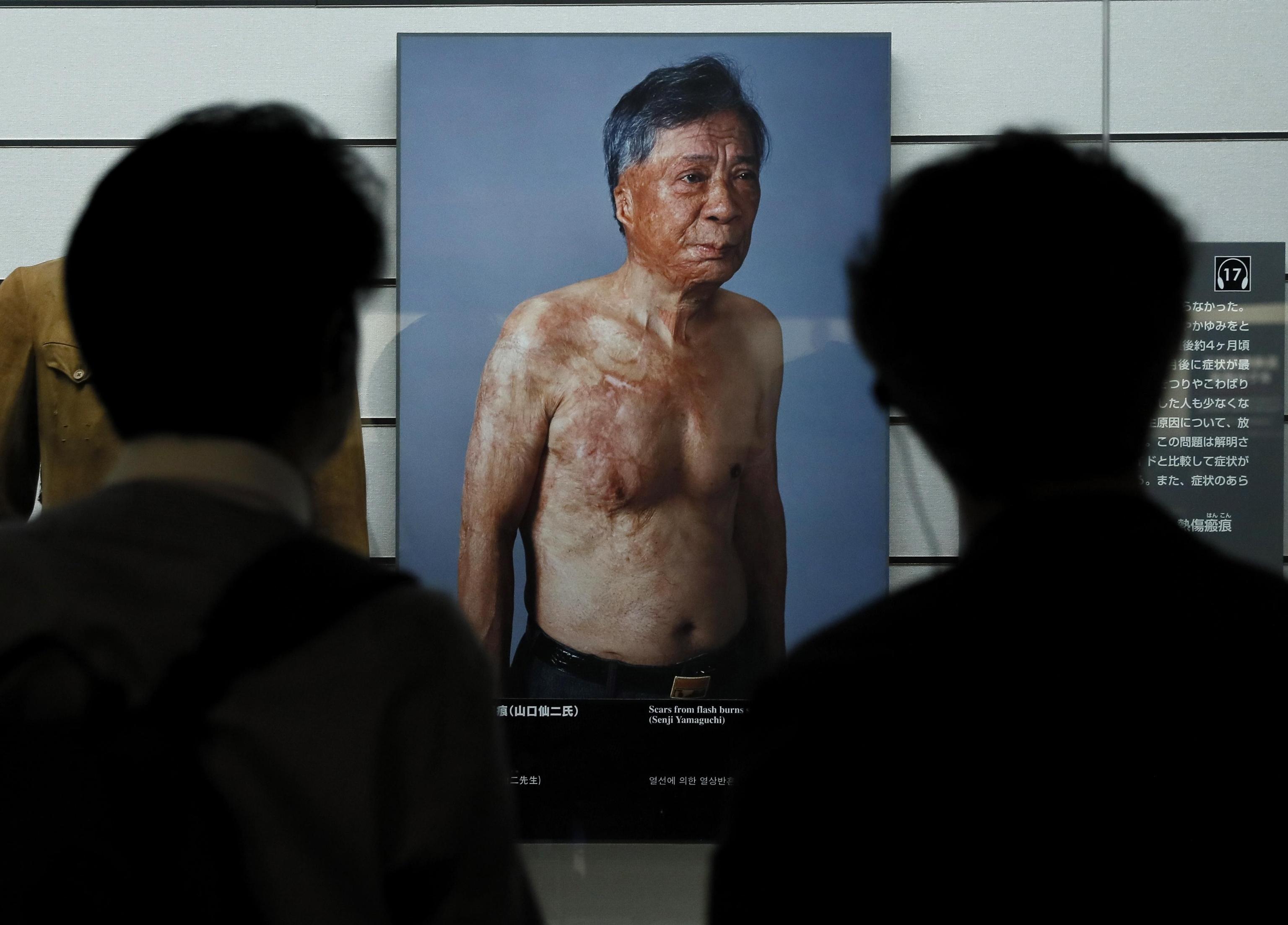 epa07839100 (FILE) - Visitors looking at a photo of Atomic Bomb survivor Senji Yamaguchi displayed at Nagasaki Atomic Bomb Museum in Nagasaki, southwestern Japan, 18 July 2019. The Vatican announced on 13 September 2019 Pope Francis will visit Japan from 23 to 26 November and the WWII atomic bombed cities of Hiroshima Nagasaki. The Pope's visit to Japan will be for the first time since John Paul II visited in 1981.  EPA/KIMIMASA MAYAMA