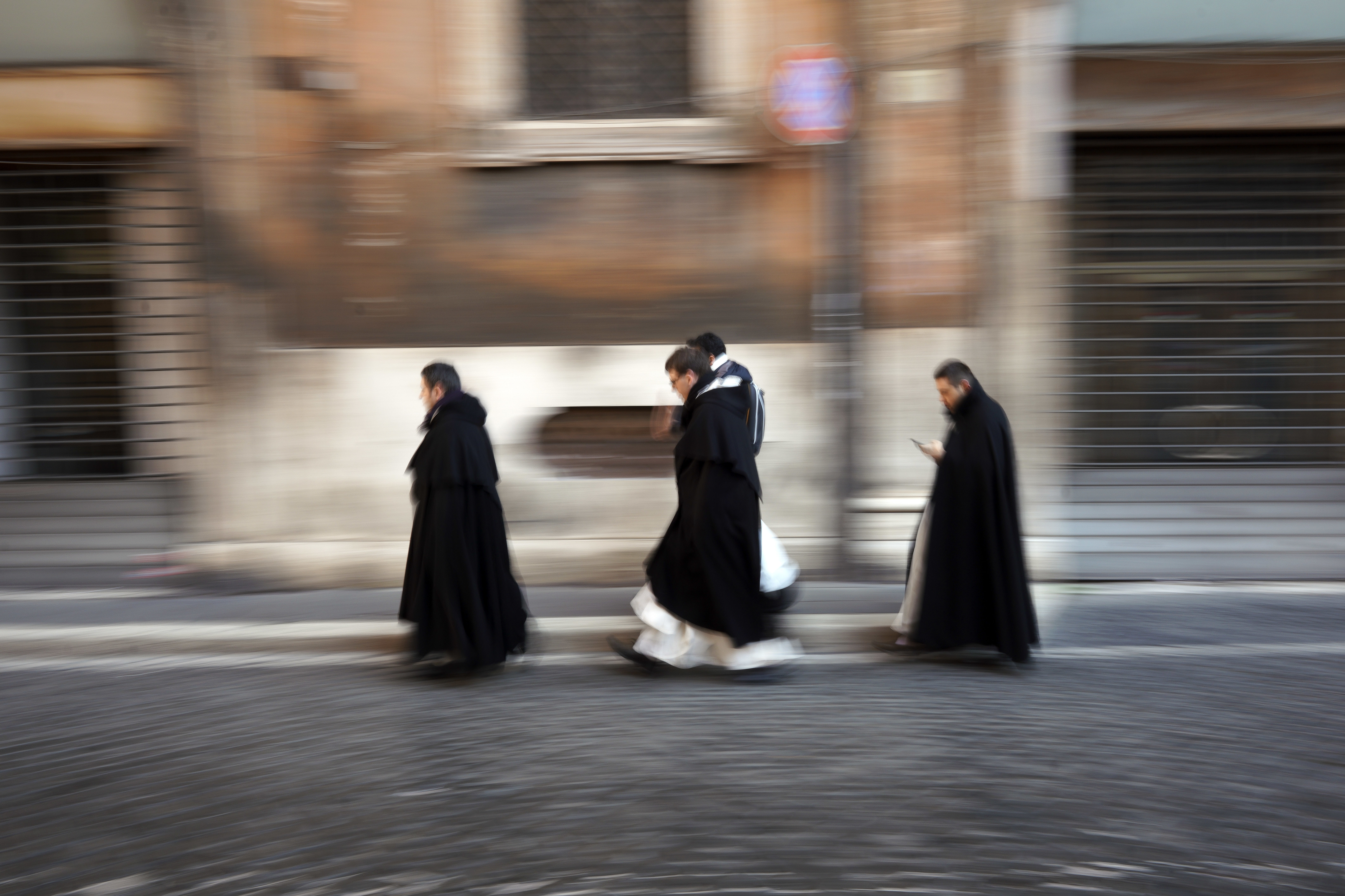 Priests walk in a street in downtown Rome, Monday, Jan. 7, 2019. (AP Photo/Andrew Medichini)