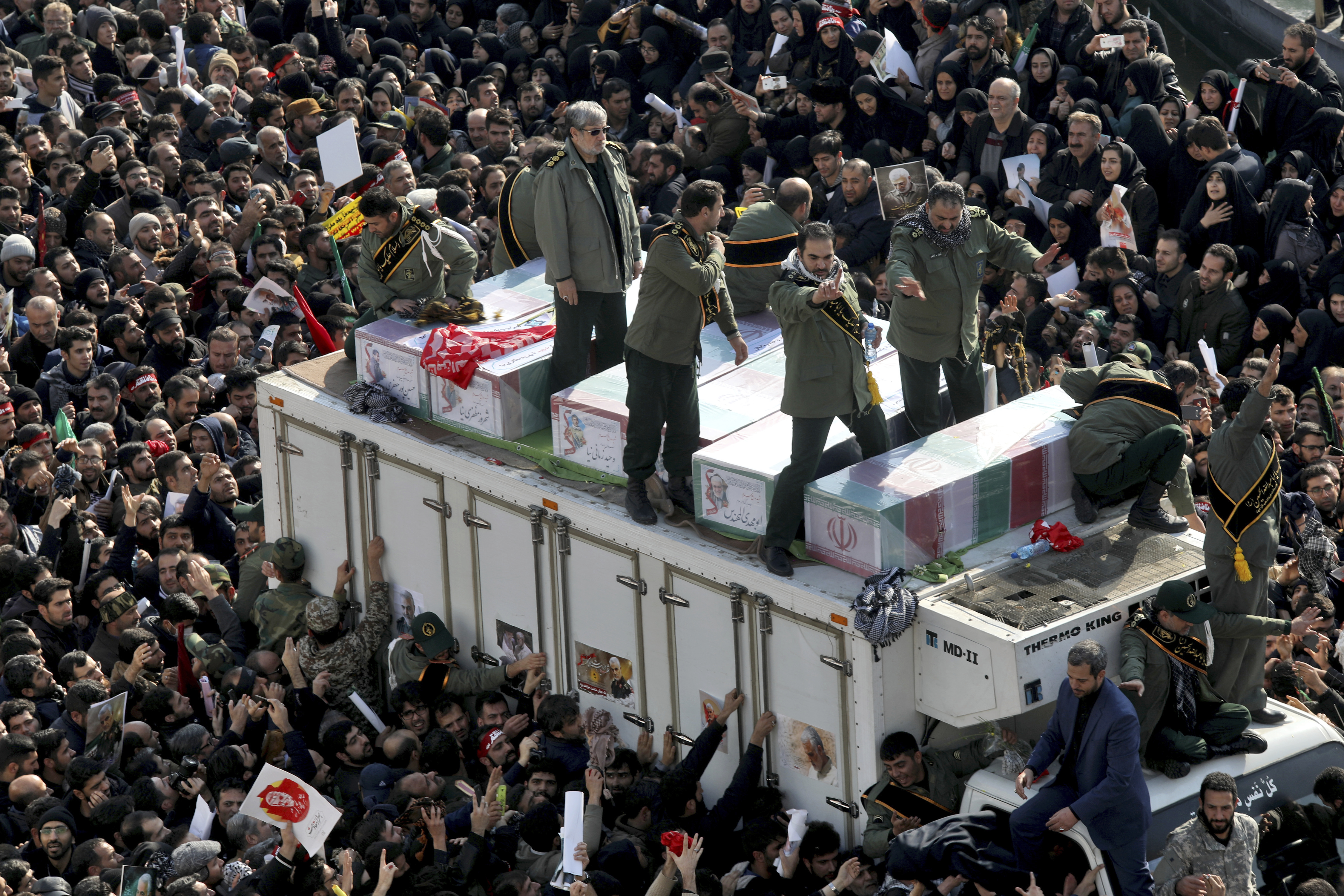 Coffins of Gen. Qassem Soleimani and others who were killed in Iraq by a U.S. drone strike, are carried on a truck surrounded by mourners during a funeral procession at the Enqelab-e-Eslami (Islamic Revolution) square in Tehran, Iran, Monday, Jan. 6, 2020. The processions mark the first time Iran honored a single man with a multi-city ceremony. Not even Ayatollah Ruhollah Khomeini, who founded the Islamic Republic, received such a processional with his death in 1989. Soleimani on Monday will lie in state at Tehran's famed Musalla mosque as the revolutionary leader did before him. (AP Photo/Ebrahim Noroozi)
