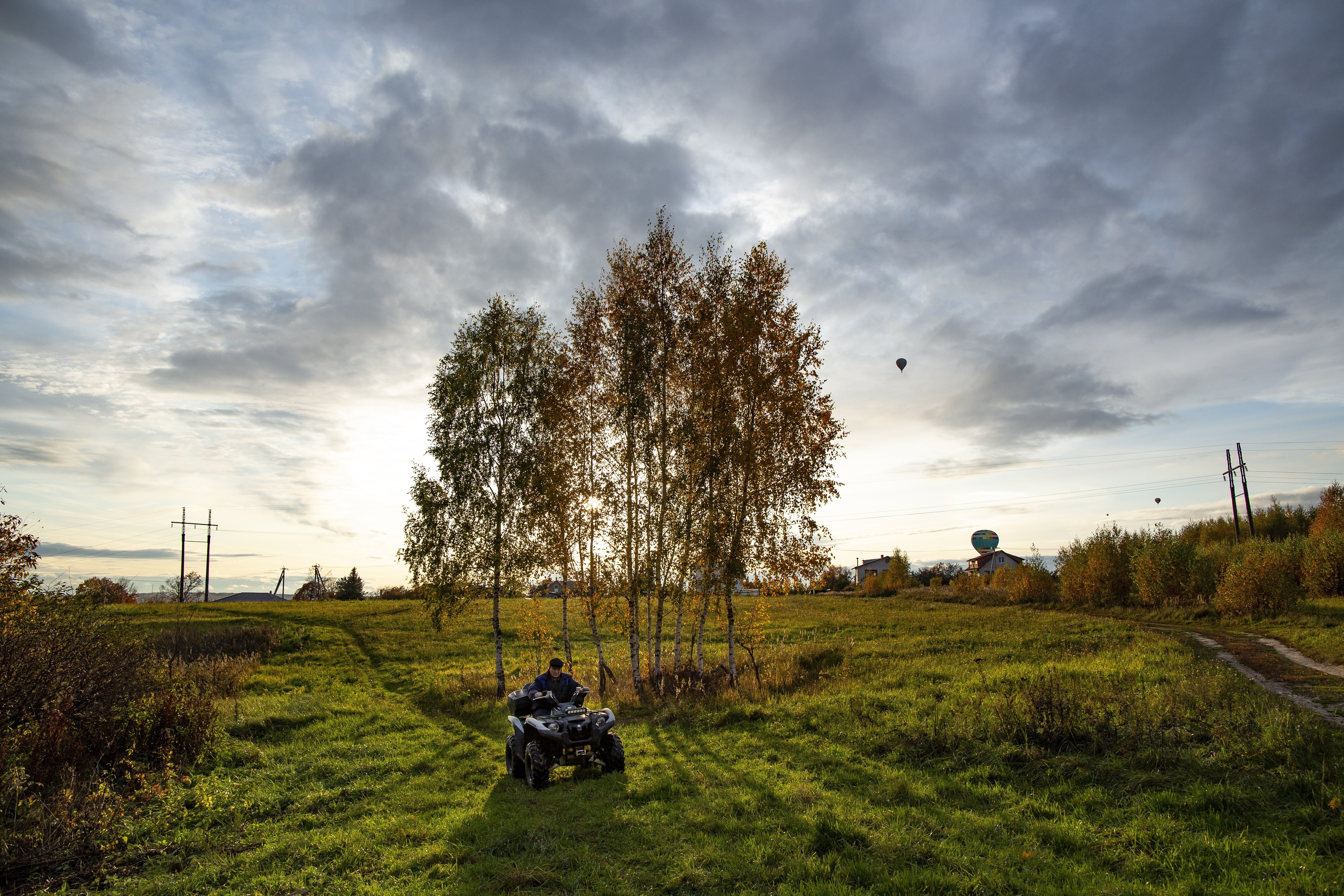 A man rides an all-terrain vehicle through an autumn field during sunset near Peremilovo village, 65 km (40,6 miles) north of Moscow, Russia, Saturday, Oct. 5, 2019. (AP Photo/Alexander Zemlianichenko)