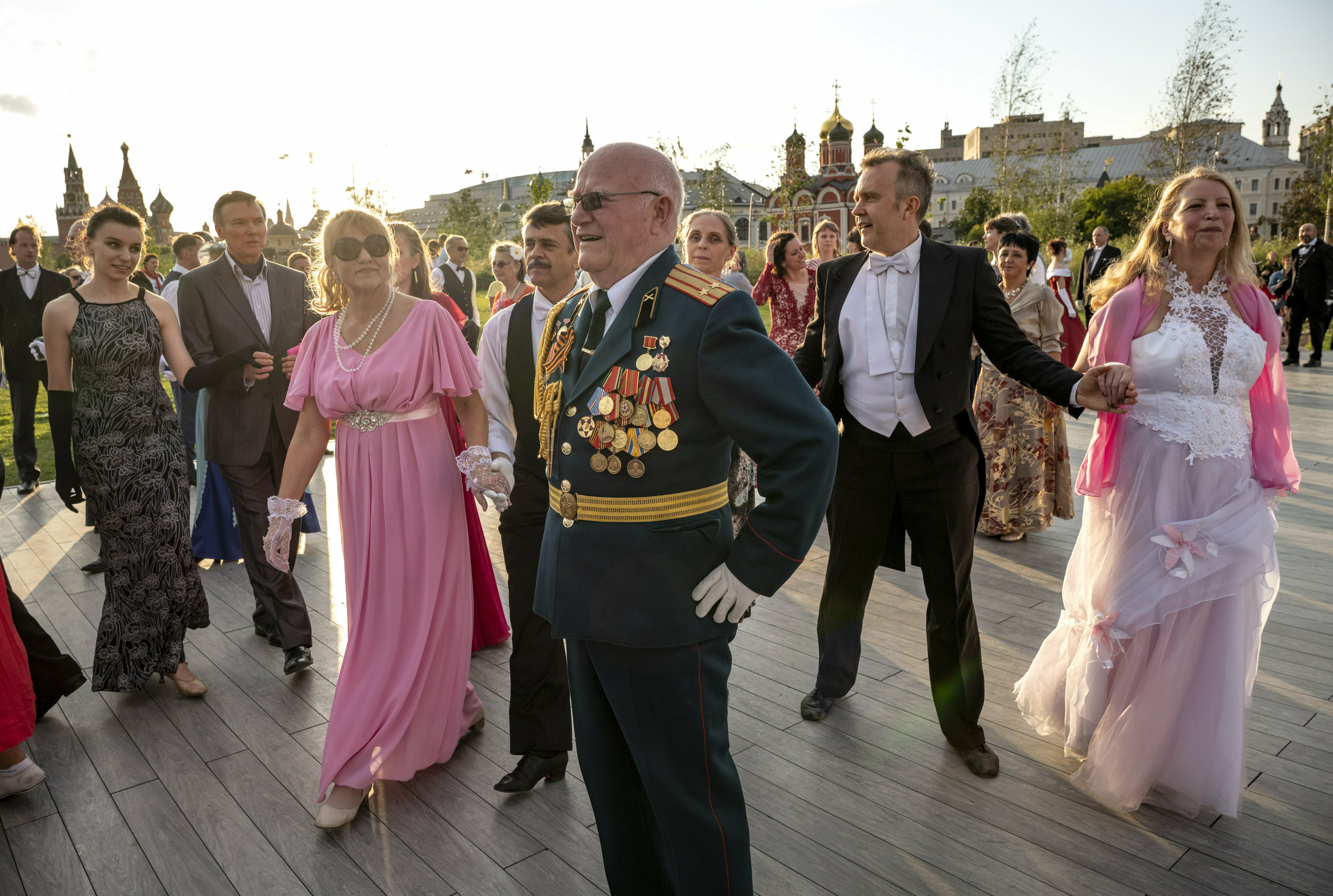 Couples prepare to dance at Zaryadye Park, with the Kremlin in the background, iin Moscow, Russia, Monday, July 8, 2019. Russia marks July 8 as the Day of Family, Love and Fidelity. (AP Photo/Alexander Zemlianichenko)