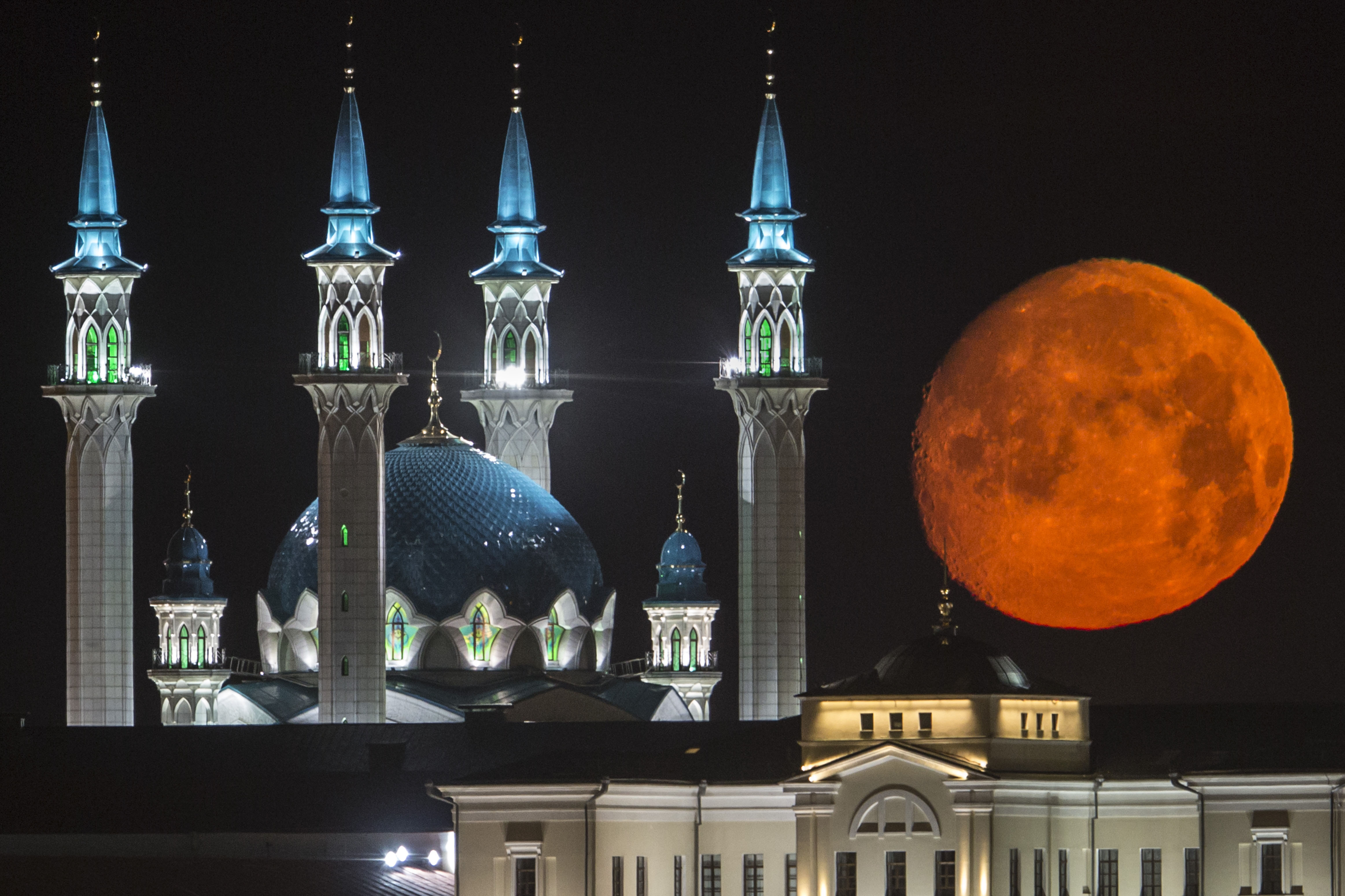 AP10ThingsToSee - The full moon rises over the illuminated Kazan Kremlin with the Qol Sharif mosque illuminated in Kazan, the capital of Tatarstan, located in Russia's Volga River area about 700 km (450 miles) east of Moscow, early Wednesday, July, 29, 2015. (AP Photo/Denis Tyrin)