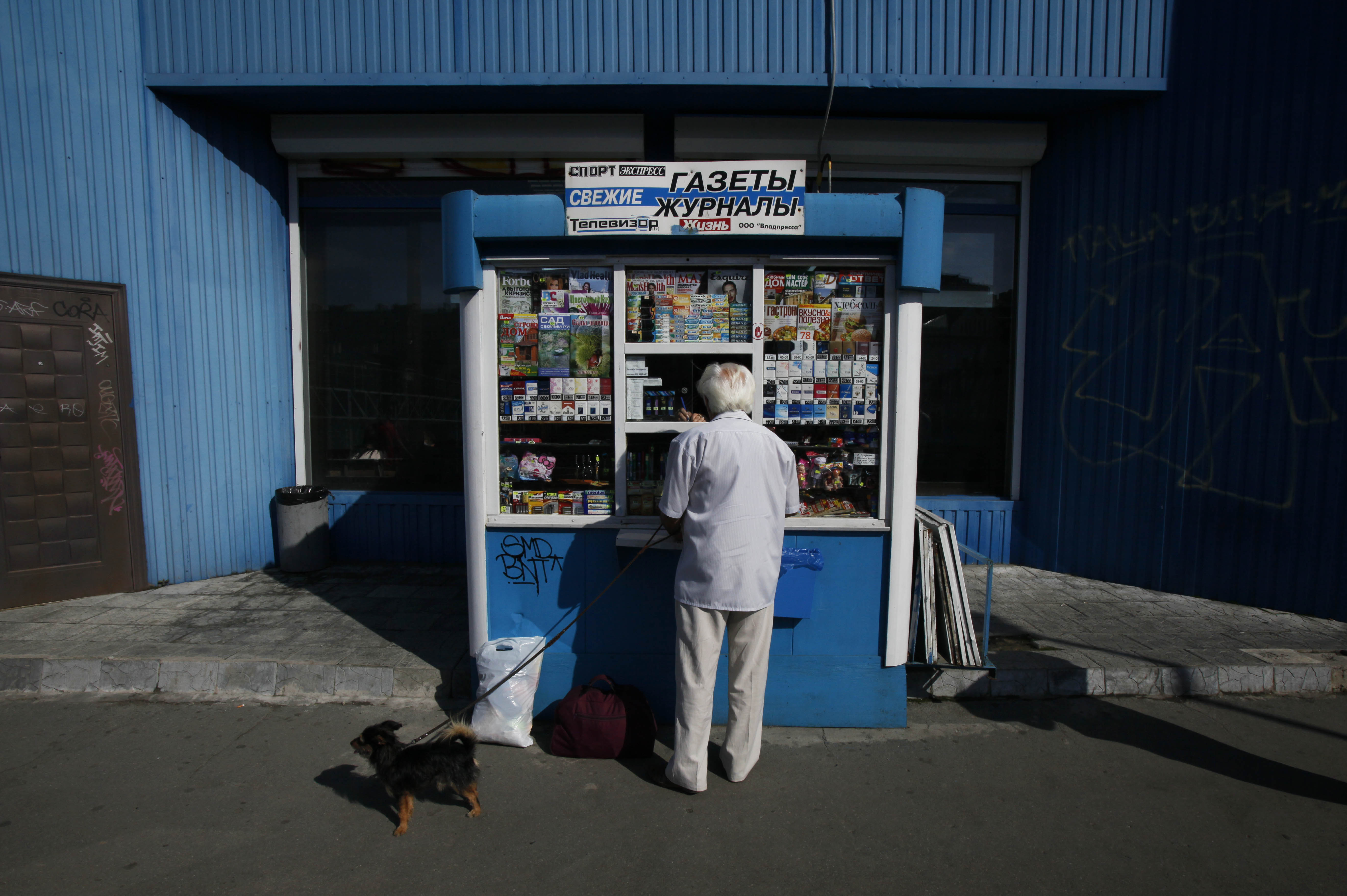 A man buys goods at a stall in Vladivostok, in eastern Russia Monday, Sept. 10, 2012. (AP Photo/Greg Baker)