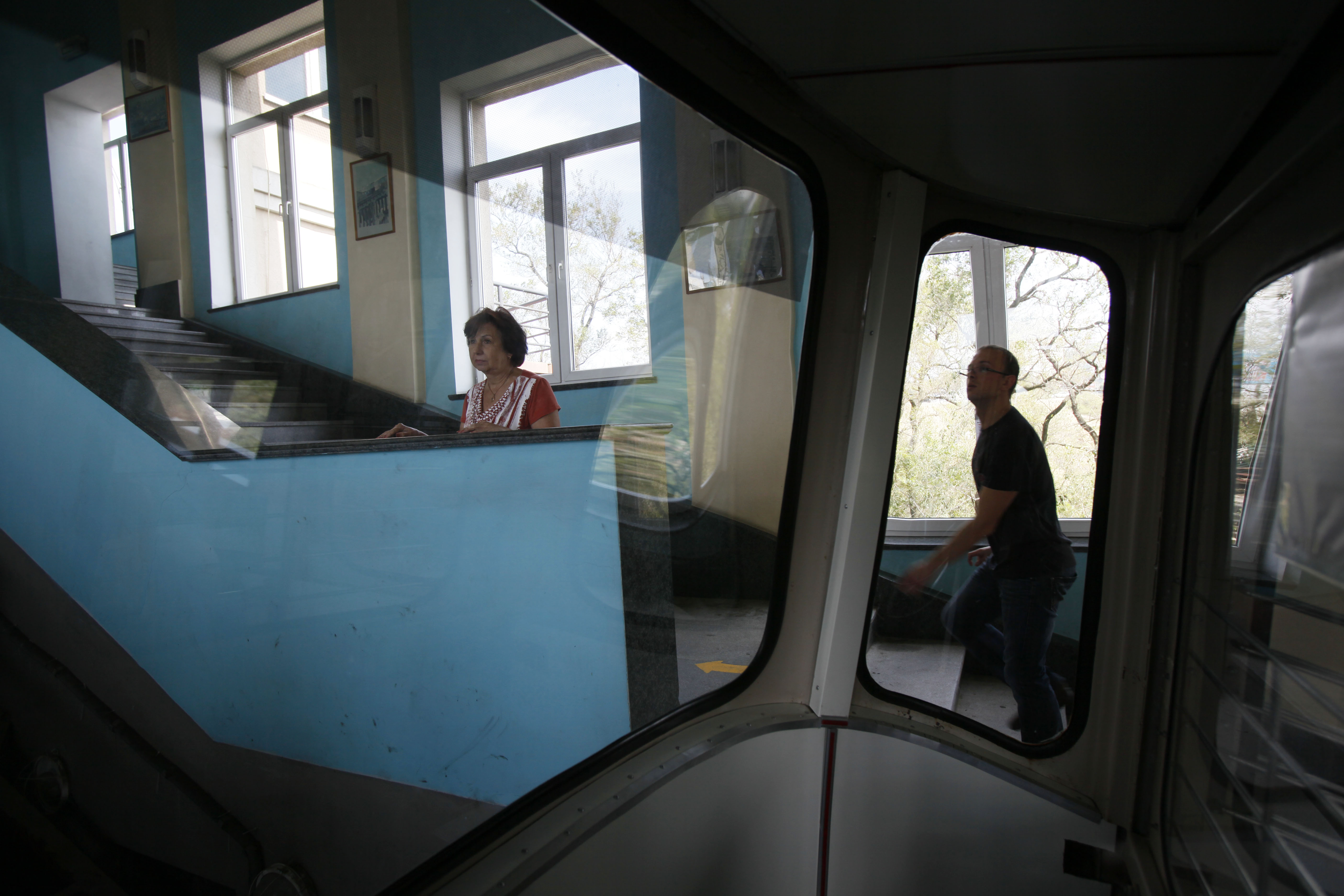 A woman is seen through the window of a funicular in Vladivostok, Russia, Monday, Sept. 10, 2012. (AP Photo/Greg Baker)