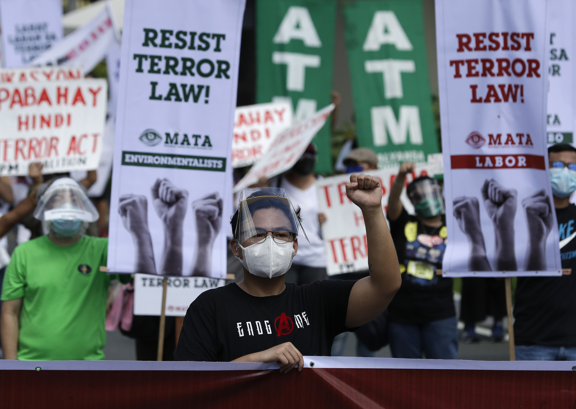 A man wearing protective mask holds a during a rally against the anti-terror law at the University of the Philippines in Manila, Philippines on Tuesday July 7, 2020. Philippine President Rodrigo Duterte recently signed a widely opposed anti-terror law which critics fear could be used against human rights defenders and to muzzle dissent. (AP Photo/Aaron Favila)