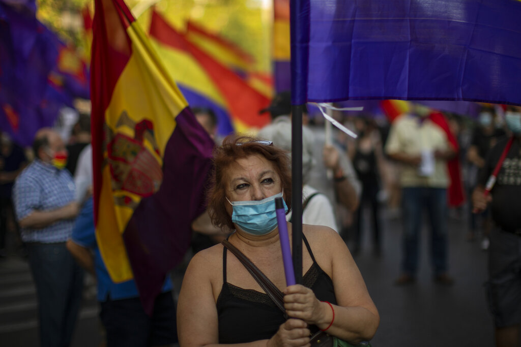 Demonstrators march during a protest against Spanish Monarchy in Madrid, Spain, Saturday, July 25, 2020. A barrage of media leaks have revealed how the king's father, former monarch Juan Carlos I, allegedly hid millions of untaxed euros in offshore funds, prompting public protests. (AP Photo/Manu Fernandez)
