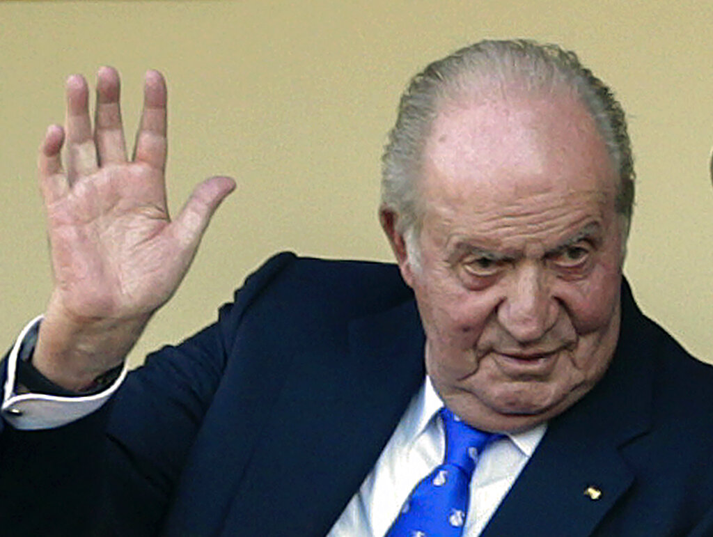 FILE - In this file photo dated Sunday, June 2, 2019, Spain's former King Juan Carlos waves at the bullring in Aranjuez, Spain.  The royal family’s website on Monday Aug. 3, 2020, published a letter from Spain’s former monarch, King Juan Carlos I, saying he is leaving Spain to live in another country, amidst a financial scandal.   (AP Photo/Andrea Comas, FILE)