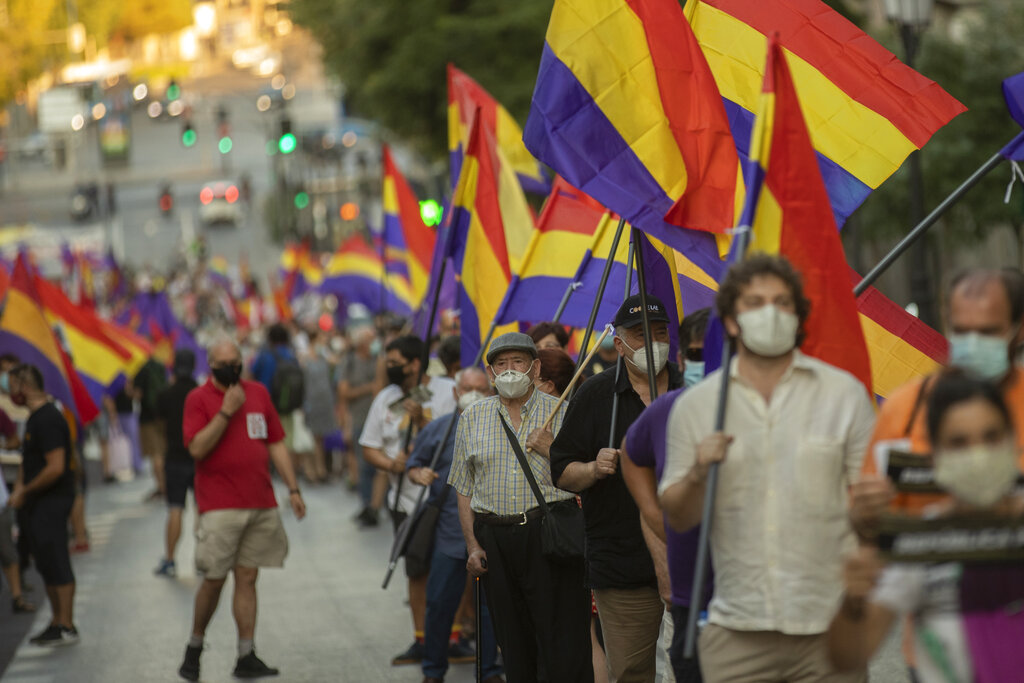 Demonstrators holding a Republican flag march during a protest against Spanish Monarchy in Madrid, Spain, Saturday, July 25, 2020.  A barrage of media leaks have revealed how the king's father, former monarch Juan Carlos I, allegedly hid millions of untaxed euros in offshore funds, prompting public protests. (AP Photo/Manu Fernandez)