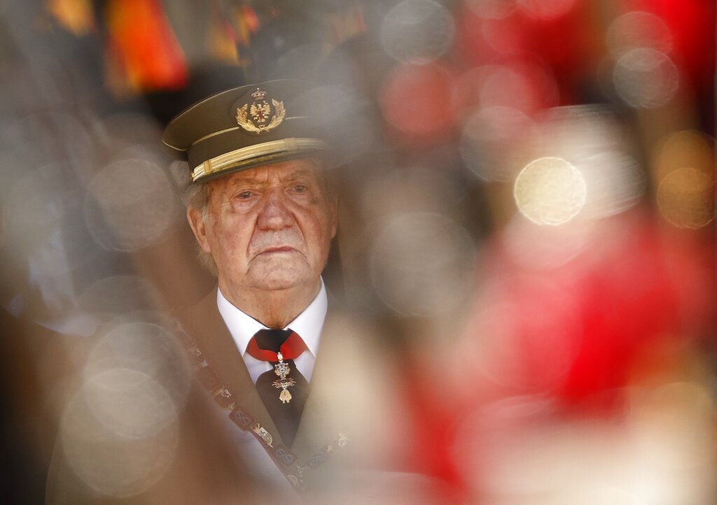 FILE - In this June 3, 2014 file photo then King Juan Carlos attends a military ceremony in San Lorenzo de El Escorial, outside Madrid, Spain. The royal family's website on Monday Aug. 3, 2020, published a letter from Spain's former monarch, King Juan Carlos I, saying he is leaving Spain to live in another country, amidst a financial scandal. (AP Photo/Daniel Ochoa de Olza, File)