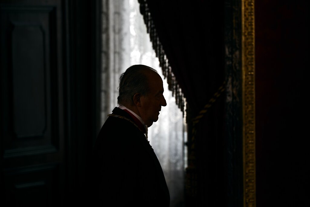 FILE - In this June 9, 2014 file photo then Spanish King Juan Carlos enters the room during a welcome ceremony before a gala dinner for Mexico's President Enrique Pena Nieto, at the Royal Palace, near Madrid. The royal family's website on Monday Aug. 3, 2020, published a letter from Spain's former monarch, King Juan Carlos I, saying he is leaving Spain to live in another country, amidst a financial scandal. (AP Photo/Daniel Ochoa de Olza, File)