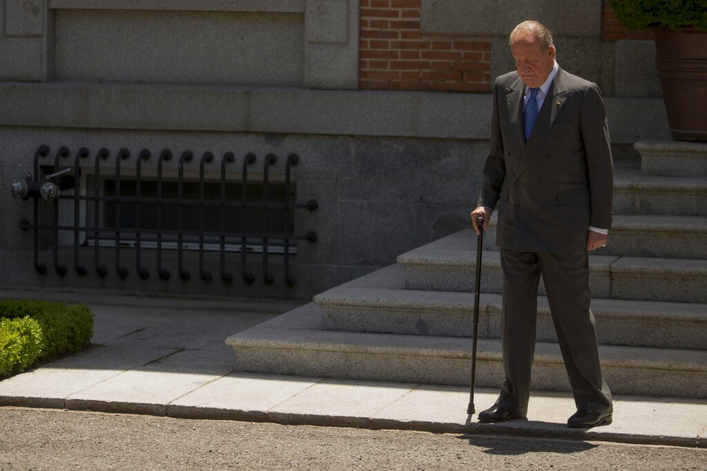 FILE - In this June 9, 2014 file photo then Spanish King Juan Carlos, looks down as he waits for Mexico's President Enrique Pena Nieto, at the Zarzuela Palace, near Madrid. The royal family's website on Monday Aug. 3, 2020, published a letter from Spain's former monarch, King Juan Carlos I, saying he is leaving Spain to live in another country, amidst a financial scandal. (AP Photo/Andres Kudacki, File)