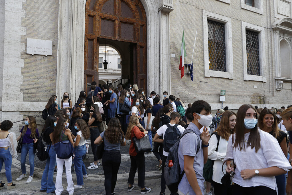 Students gather outside the Visconti high school on the first day of the reopening in Rome, Monday, Sept. 14, 2020. Italian schools closed nationwide on March 5 and never reopened as Italy became the epicenter of the pandemic in Europe. (AP Photo/Gregorio Borgia)