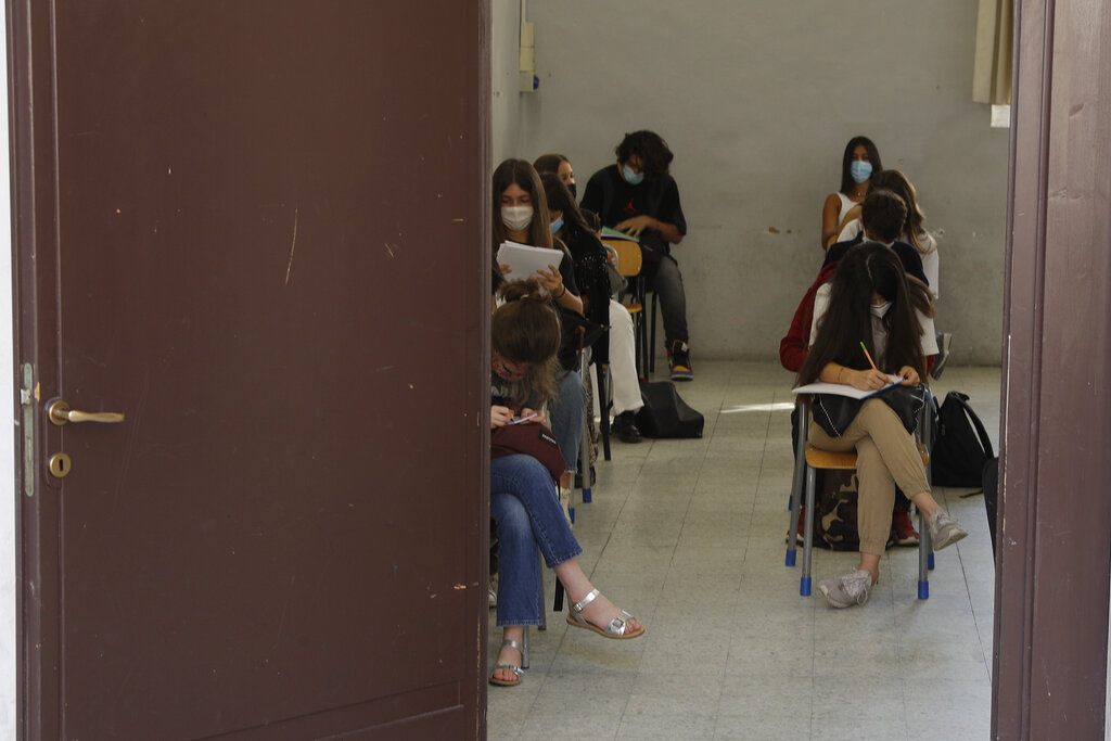 Students sit in their classroom at the Visconti high school, in Rome, Monday, Sept. 14, 2020. The reopening of Italian schools marks an important step in a return to pre-lockdown routine after six long months, long after the buzz returned to shopping malls, theaters and beaches, and another test of the government’s management of the pandemic. Italian schools closed nationwide on March 5 and never reopened as Italy became the epicenter of the pandemic in Europe. (AP Photo/Gregorio Borgia)