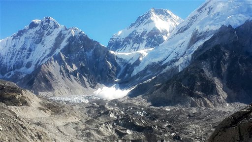 In this Tuesday, Sept. 1, 2015 photo, an avalanche lands at Everest Base Camp, in front of Mt. Khumbutse, left, Mt. Changtse, center, and Mt. Lho La, in Nepal. Earlier last month Nepal announced the opening of Mount Everest to climbers for the first time since an earthquake-triggered avalanche at base camp in April killed 19 mountaineers and ended the popular spring climbing season. Since April's earthquake, which killed nearly 9,000 people, Nepal has been desperate to bring back the tens of thousands of tourists who enjoy trekking the country's mountain trails and climbing its Himalayan peaks. (AP Photo/Tashi Sherpa)