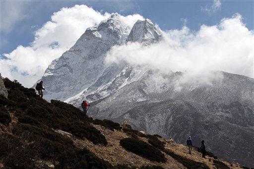 In this March 5, 2016 photo, trekkers hike at the base of Mount Ama Dablam (6856 meters) in the Khumbu region of Nepal. (AP Photo/Tashi Sherpa)