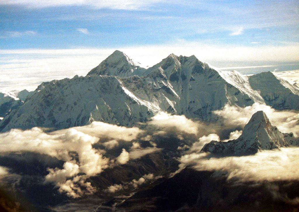 FILE - In this Aug. 26, 2000, file photo, the southern face of Mount Everest including Mount Lhotse, middle right, soars above the monsoon clouds at the border of Nepal and Tibet. Pemba Sherpa of the Xtreme Climbers Treks and Expeditions says American climbers James Morrison and Hilaree Nelson successfully skied down Mount Lhotse’s 8,516-meter (27,940-foot) summit after scaling it on Sunday. (AP Photo/John McConnico, File)