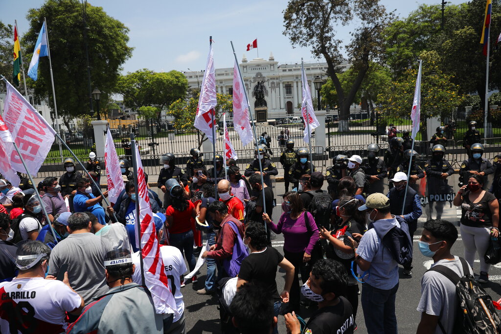 Protesters asking for the resignation of interim President Manuel Merino gather outside Congress in Lima, Peru, Sunday, Nov. 15, 2020. Merino resigned Sunday following a wave of protests against the dismissal by Congress of President Martin Vizcarra. (AP Photo/Rodrigo Abd)