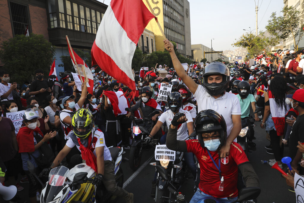 A caravan of demonstrators on motorcycles ride after interim President Manuel Merino resigned his post, in Lima, Peru, Sunday, Nov. 15, 2020. Merino announced his resignation following massive protests, unleashed when lawmakers ousted President Martin Vizcarra. (AP Photo/Rodrigo Abd)