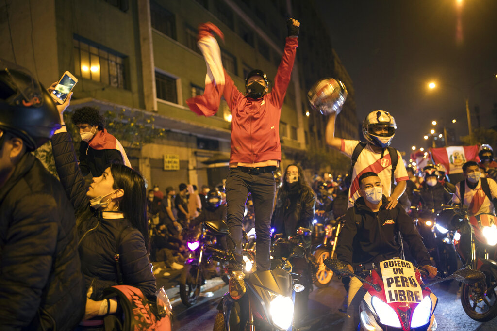 A caravan of demonstrators on motorcycles ride as they wait for news on who will be the country's next president, in Lima, Peru, Sunday, Nov. 15, 2020. Manuel Merino announced his resignation following massive protests, unleashed when lawmakers ousted President Martin Vizcarra. (AP Photo/Rodrigo Abd)