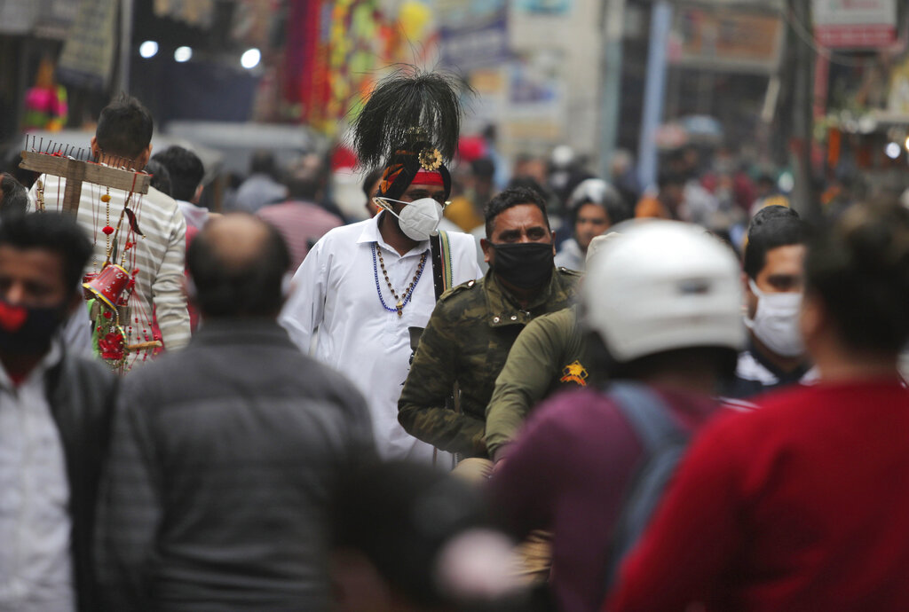 Indians wearing face masks as a precautionary measure against the coronavirus crowd a market during Diwali, the Hindu festival of lights, in Jammu, India, Saturday, Nov. 14, 2020. (AP Photo/ Channi Anand)