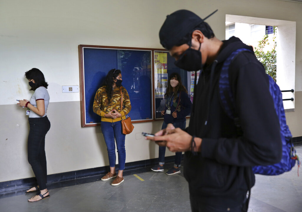 Students wearing face masks as a precaution against the coronavirus line up to be tested for COVID-19 at St. Joseph's College in Bengaluru, India, Monday, Nov.16, 2020. A country of nearly 1.4 billion people, India is the world's second most coronavirus affected country after the United States. Colleges in Bengaluru are scheduled to reopen Tuesday. (AP Photo/Aijaz Rahi)