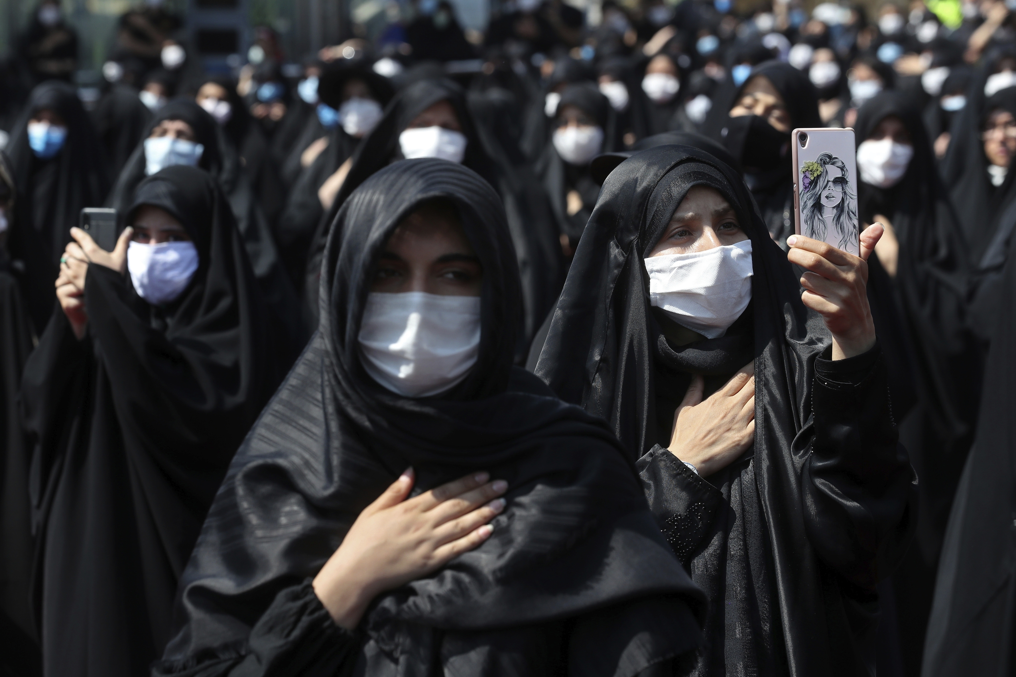 Iran FILE - In this Sunday, Aug. 30, 2020 file photo, people wearing protective face masks to help prevent spread of the coronavirus mourn during an annual ceremony commemorating Ashoura in Tehran, Iran. The confirmed death toll from the coronavirus has gone over 50,000 in the Middle East as the pandemic continues. That's according to a count Thursday, Sept. 3, 2020, from The Associated Press, based on official numbers offered by health authorities across the region. (AP Photo/Ebrahim Noroozi, File)