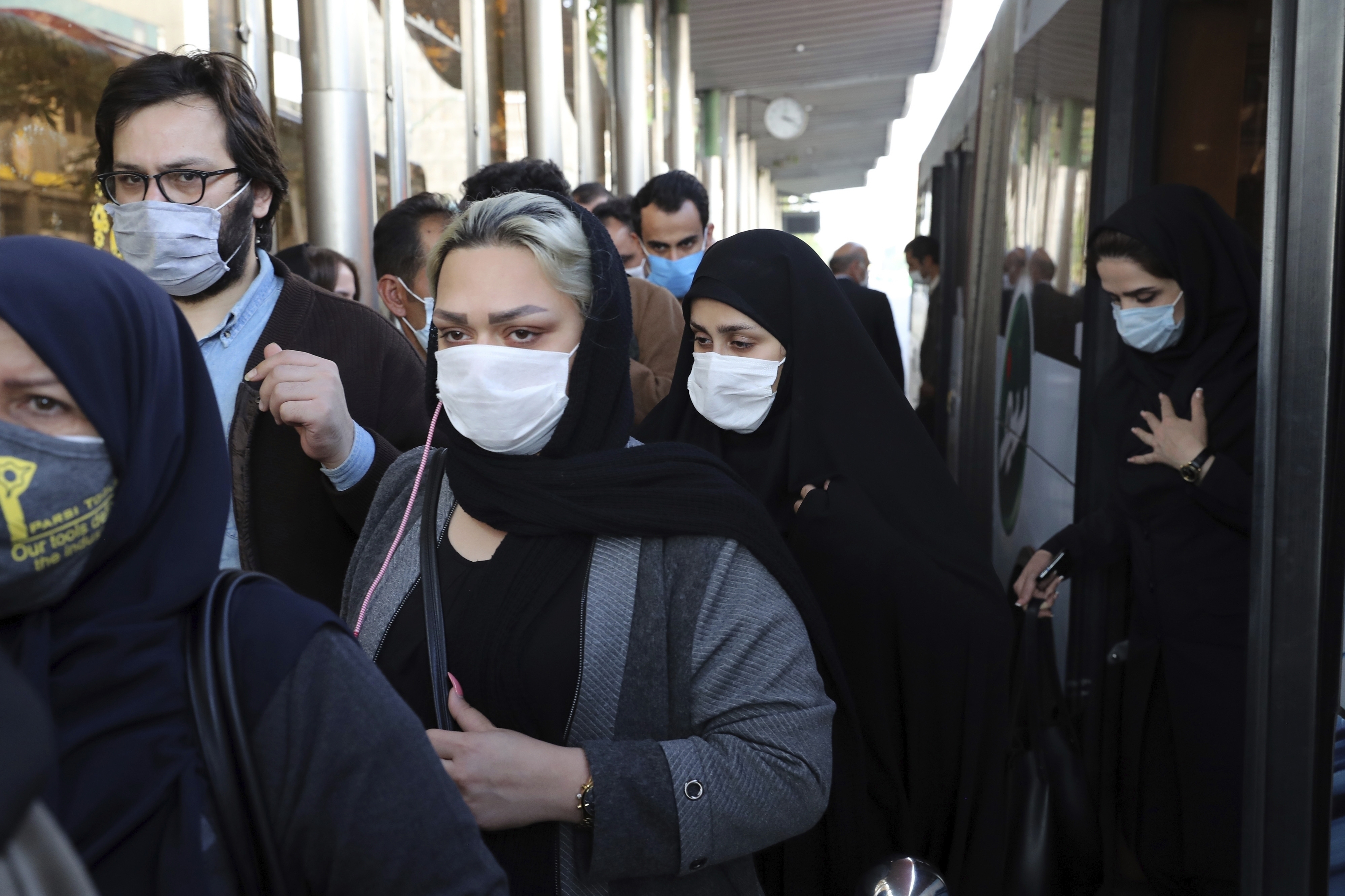 FILE - In this Oct. 11, 2020, file photo, people wear protective face masks to help prevent the spread of the coronavirus in downtown Tehran, Iran. On Tuesday, Nov. 10, 2020, Iran was set to impose a nightly business curfew in its capital for the first time as the country battles a major surge in coronavirus infections. (AP Photo/Ebrahim Noroozi, File)