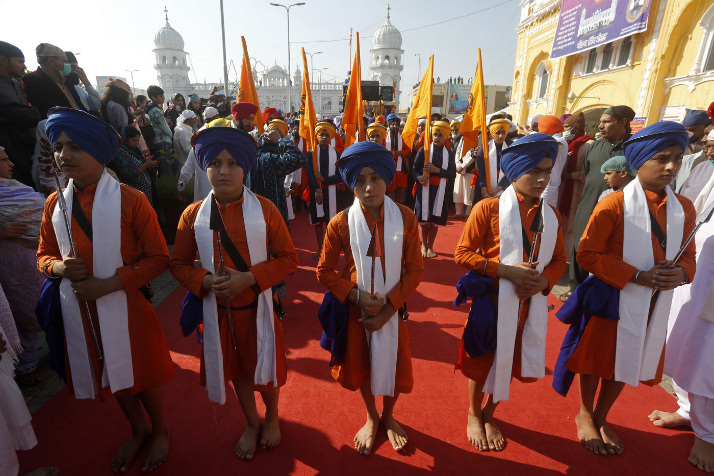 Sikh boys in traditional dress attend a religious festival to celebrate the birth anniversary of their spiritual leader Baba Guru Nanak Dev, at Nankana Sahib, near Lahore, Pakistan, Monday, Nov. 30, 2020. Thousands of pilgrims from various countries arrived in Pakistan to participate in three-day festival to celebrate the 551st birth anniversary of the founder of the Sikh religion. (AP Photo/K.M. Chaudary)