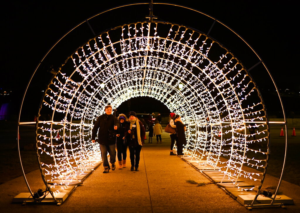 People overlook the millions of holiday lights during the annual Winter Festival of Lights in Niagara Falls, Ontario, Sunday, Dec. 6, 2020. (Nathan Denette/The Canadian Press via AP)