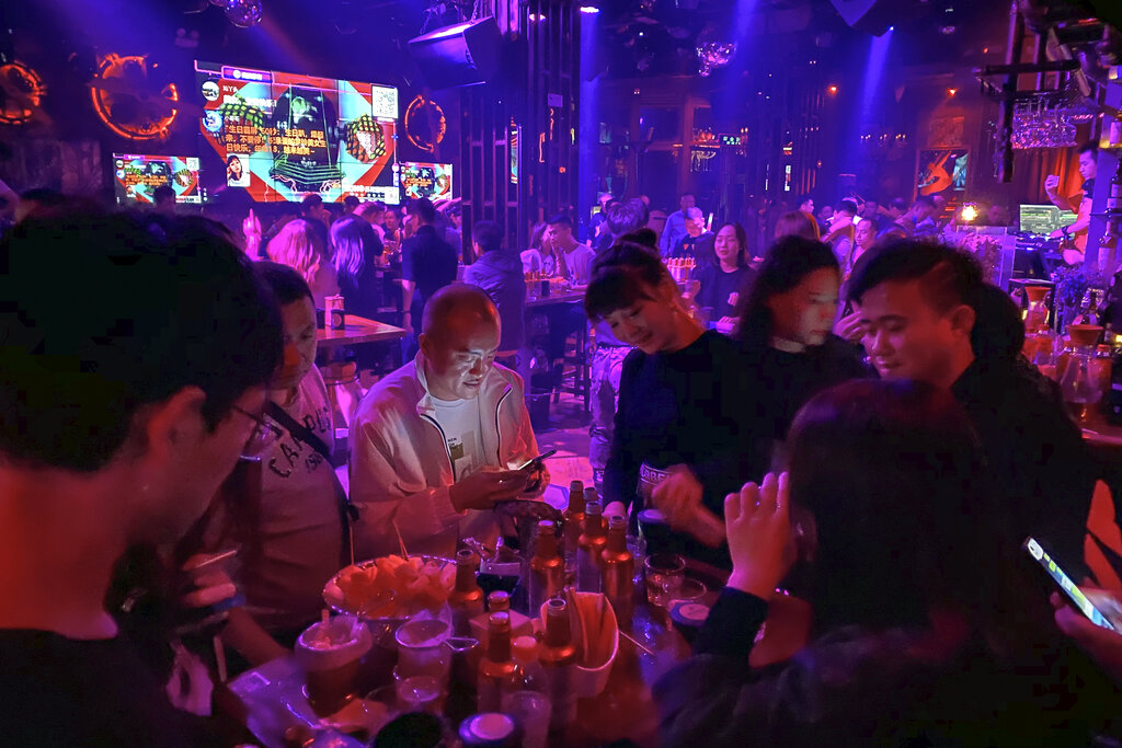 Residents enjoy night life at a club in Wuhan in central China's Hubei province on Sunday, Oct. 18, 2020. (AP Photo/Ng Han Guan)