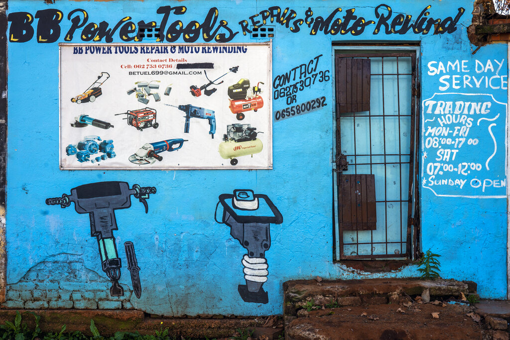 A power tool repair shop remains closed in the Soweto township in Johannesburg, South Africa, Friday, April 17, 2020. Many small businesses considered non-essential risk shutting down for good as South Africa is under a strict five-week lockdown in an effort to fight the coronavirus pandemic. (AP Photo/Jerome Delay)