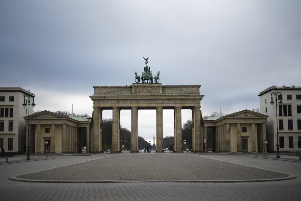 The Pariser Platz square in front of the German landmark Brandenburg Gate is deserted in Berlin, Germany, on March 30, 2020, amid the coronavirus pandemic. (AP Photo/Markus Schreiber)
