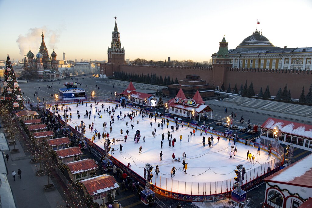 The ice rink in Red Square decorated for Christmas and New Year celebrations seen from a roof of the Moscow GUM State Department store with the Spasskaya Tower, center, the St. Basil's Cathedral, left, and the Kremlin Wall, right, after sunset in Moscow, Russia, Thursday, Dec. 10, 2020. Many of Christmas markets were canceled or diminished in Moscow, the capital of Russia, because of the coronavirus pandemic this year. (AP Photo/Alexander Zemlianichenko)