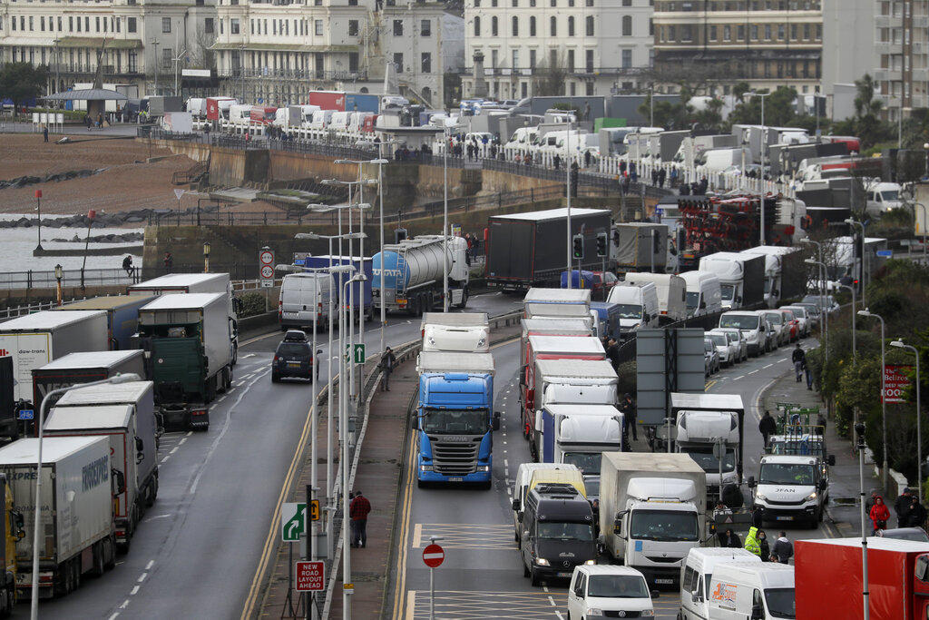 Trucks parked on the roadside whilst the Port remains closed, in Dover, southern England, Tuesday, Dec. 22, 2020.  Trucks waiting to get out of Britain backed up for miles and people were left stranded at airports as dozens of countries around the world slapped tough travel restrictions on the U.K. because of a new and seemingly more contagious strain of the coronavirus in England. (AP Photo/Kirsty Wigglesworth)