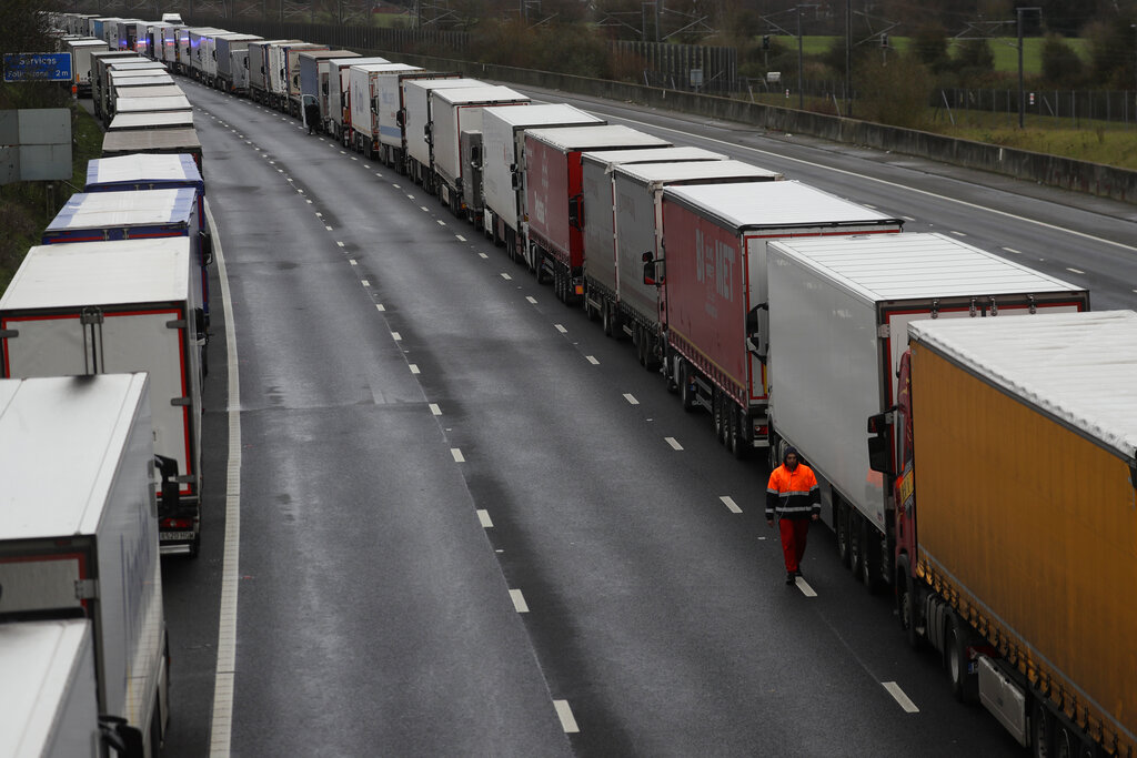 Trucks are parked on the M20 motorway as part of Operation Stack, whilst the Port of Dover remains closed, in southern England, Tuesday, Dec. 22, 2020. Trucks waiting to get out of Britain backed up for miles and people were left stranded as dozens of countries around the world slapped tough travel restrictions on the U.K. because of a new and seemingly more contagious strain of the coronavirus in England.(AP Photo/Kirsty Wigglesworth)