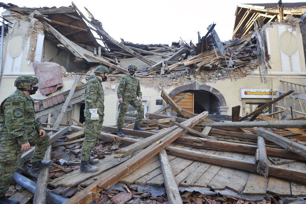 Soldiers inspect the remains of a building damaged in an earthquake, in Petrinja, Croatia, Tuesday, Dec. 29, 2020. A strong earthquake has hit central Croatia and caused major damage and at least one death in a town southeast of the capital. (AP Photo)