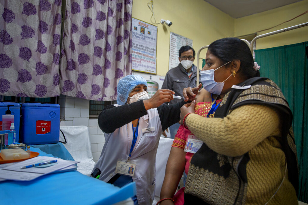 A health worker engages in a COVID-19 vaccine delivery system trial in New Delhi, India, Saturday, Jan. 2, 2021. India tested its COVID-19 vaccine delivery system with a nationwide trial on Saturday as it prepares to roll-out an inoculation program to stem the coronavirus pandemic. Saturday’s exercise included necessary data entry into an online platform for monitoring vaccine delivery, along with testing of cold storage and transportation arrangements for the vaccine, the health ministry had said.(AP Photo/Altaf Qadri)