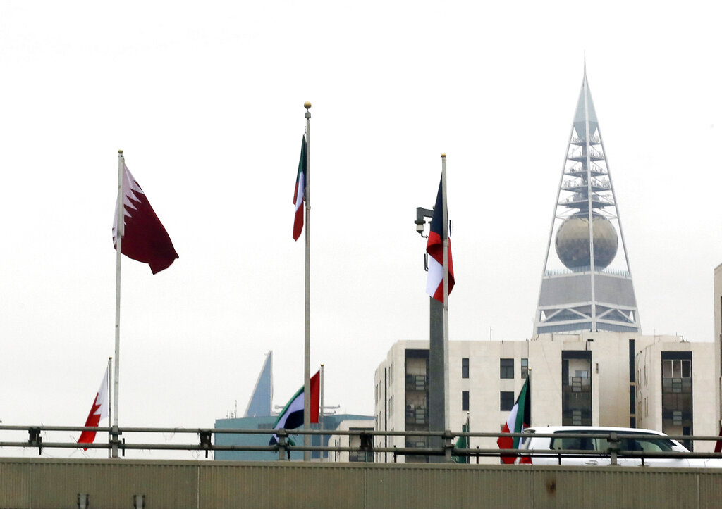 A Qatari flag, left, is seen with other gulf countries flags in front of the Al-Faislia Tower in Riyadh, Saudi Arabia, Monday, Dec. 9, 2019, ahead of the Gulf Cooperation Council, GCC, 40th summit. (AP Photo/Amr Nabil)