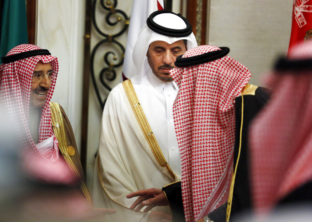 Qatar's Prime Minister Abdullah bin Nasser bin Khalifa al-Thani, center, looks at Saudi King Salman, right, as he talks to Kuwait's emir, Sheikh Sabah Al Ahmad Al Sabah, left, during the 40th Gulf Cooperation Council Summit in Riyadh, Saudi Arabia, Tuesday, Dec. 10, 2019.  (AP Photo/Amr Nabil)