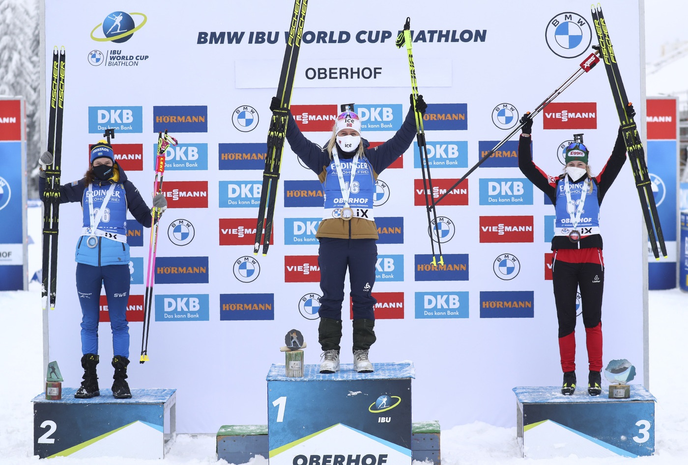 Winner Tiril Eckhoff of Norway, center, runner up Hanna Oeberg of Sweden, left, and Austria's Lisa Theres Hauser who finished third celebrate on the podium after the women's 7.5 km sprint race at the Biathlon World Cup in Oberhof, Germany, Friday, Jan. 8, 2021. (AP Photo/Matthias Schrader)