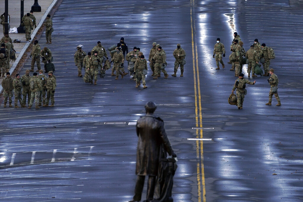 National Guard members walk in a security zone ahead of President-elect Joe Biden inauguration during the 59th Presidential Inauguration at the U.S. Capitol in Washington, Wednesday, Jan. 20, 2021. (AP Photo/Andrew Harnik)