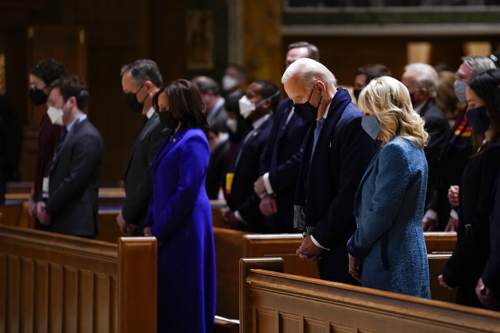 President-elect Joe Biden and his wife Jill Biden attend Mass at the Cathedral of St. Matthew the Apostle during Inauguration Day ceremonies Wednesday, Jan. 20, 2021, in Washington. Vice President-elect Kamala Harris and her husband Doug Emhoff are at left. (AP Photo/Evan Vucci)