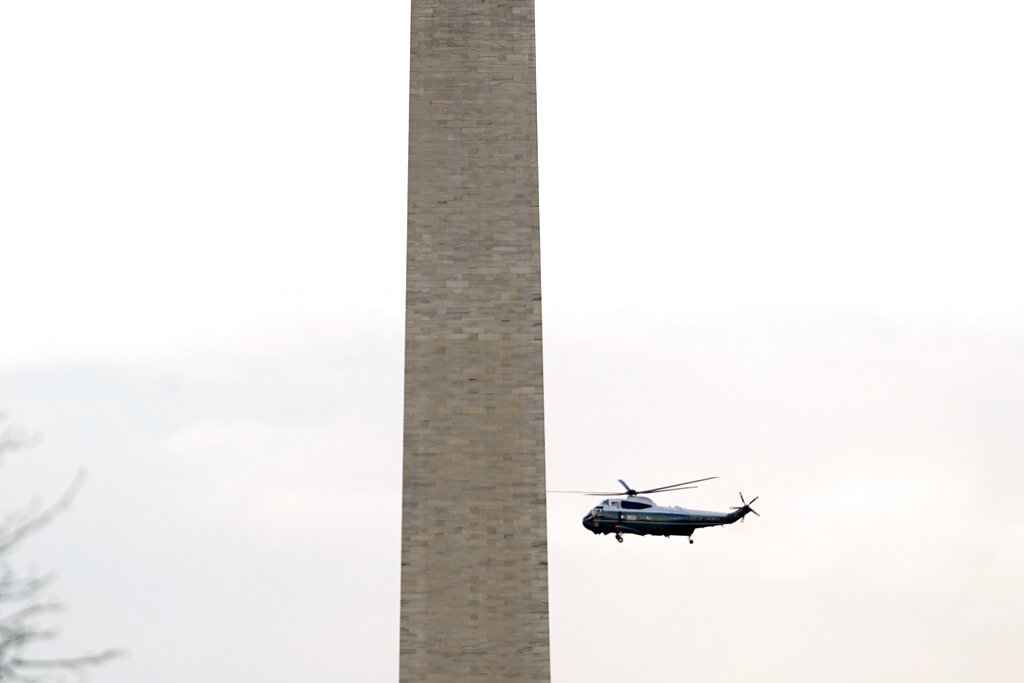 Marine One carrying President Donald Trump flies near the Washington Monument as he leaves the White House ahead of the 59th Presidential Inauguration for President-elect Joe Biden at the U.S. Capitol in Washington, Wednesday, Jan. 20, 2021. (AP Photo/Andrew Harnik)
