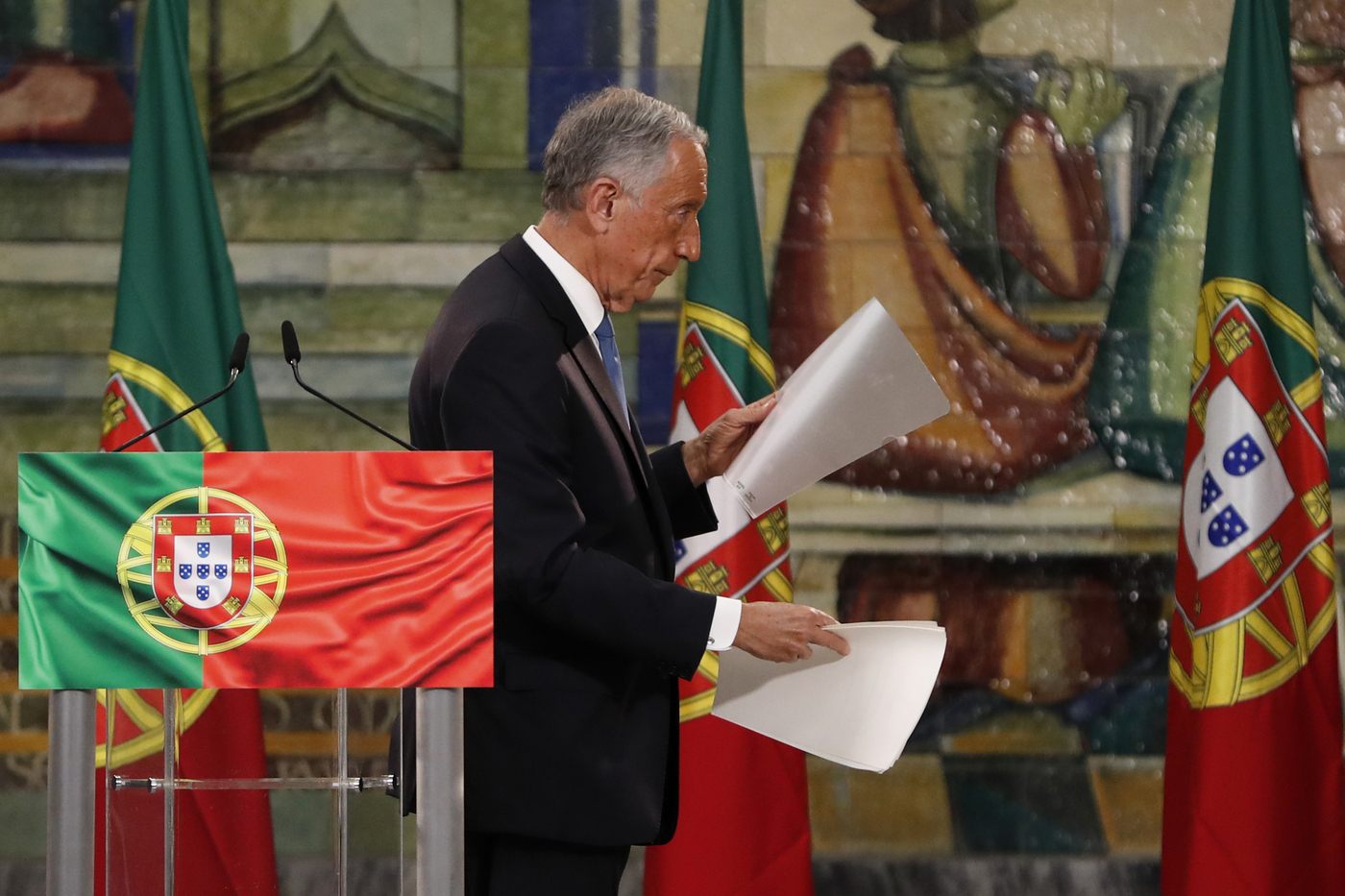 Incumbent Marcelo Rebelo de Sousa leaves the lectern after delivering a speech following the results of Portugal's presidential election, in Lisbon, Monday, Jan. 25, 2021. Rebelo de Sousa was reelected for a second five-year term. (AP Photo/Armando Franca)