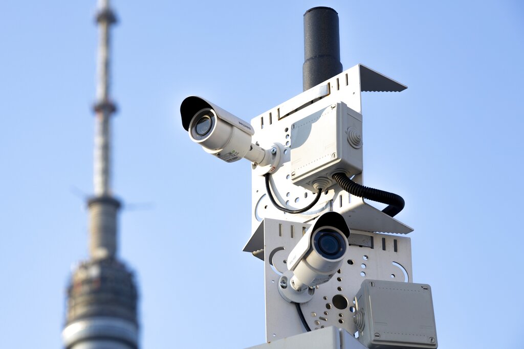 In this photo taken on Saturday, Feb. 22, 2020, two surveillance camera are seen in a street in Moscow, Russia. Moscow's city officials announced a slew of policies aimed at tracking down the few Chinese nationals remaining in the city, including raids on hotels and the use of facial recognition technology to target people evading quarantine. (AP Photo/Alexander Zemlianichenko)
