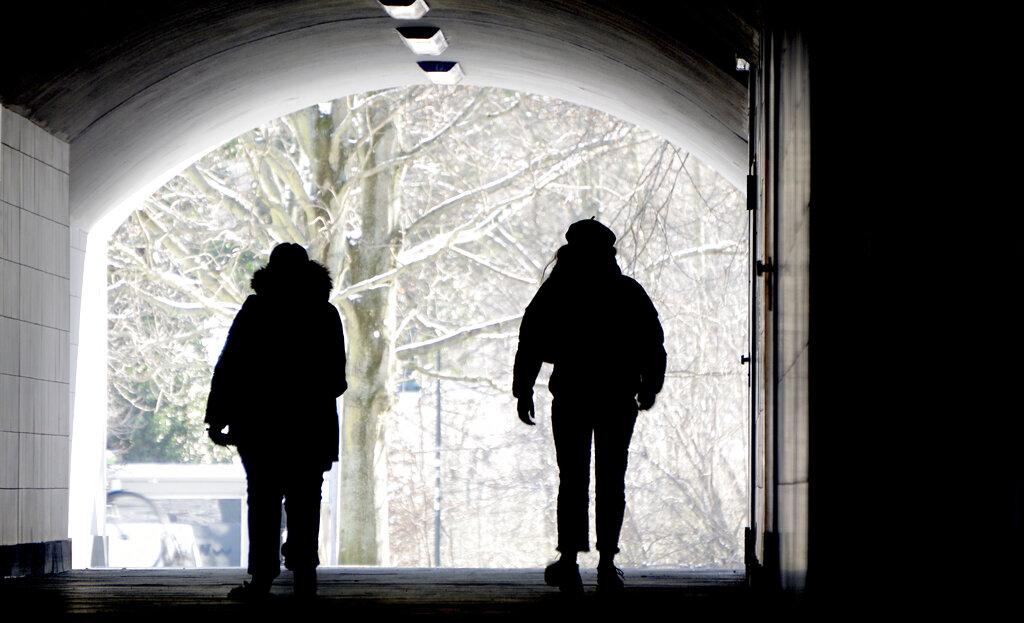 Two persons walks through a pedestrian subway in Berlin, Germany, Monday, Feb. 1, 2021. (AP Photo/Michael Sohn)