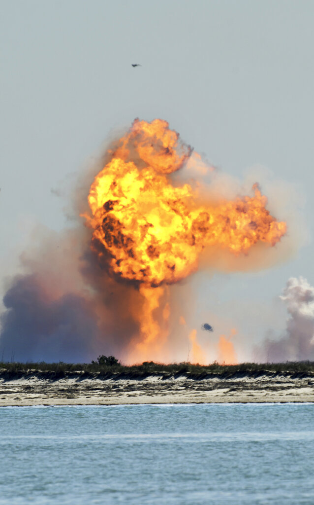 SpaceX's bullet-shaped Starship prototype explodes after crashing while attempting to land following a successful test launch, Tuesday, Feb. 2, 2021, in Boca Chica, Texas. (Miguel Roberts/The Brownsville Herald via AP)