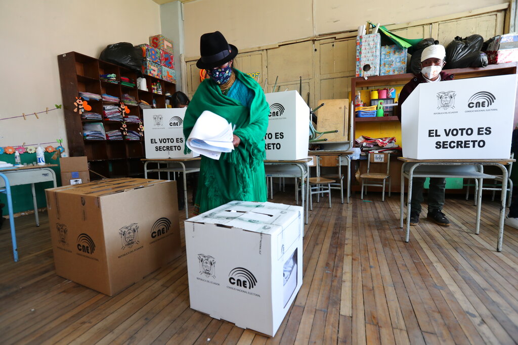 A voter carries her ballots during general elections in Cangahua, Ecuador, Sunday, Feb. 7, 2021. Amidst the new coronavirus pandemic Ecuadoreans went to the polls in a first round presidential and legislative elections. (AP Photo/Dolores Ochoa)